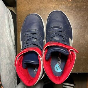 Red and blue kid puma high top.